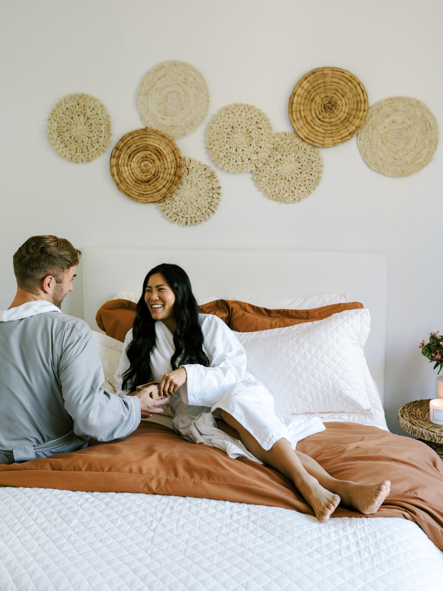 Couple enjoying a romantic staycation enjoying breakfast in bed together