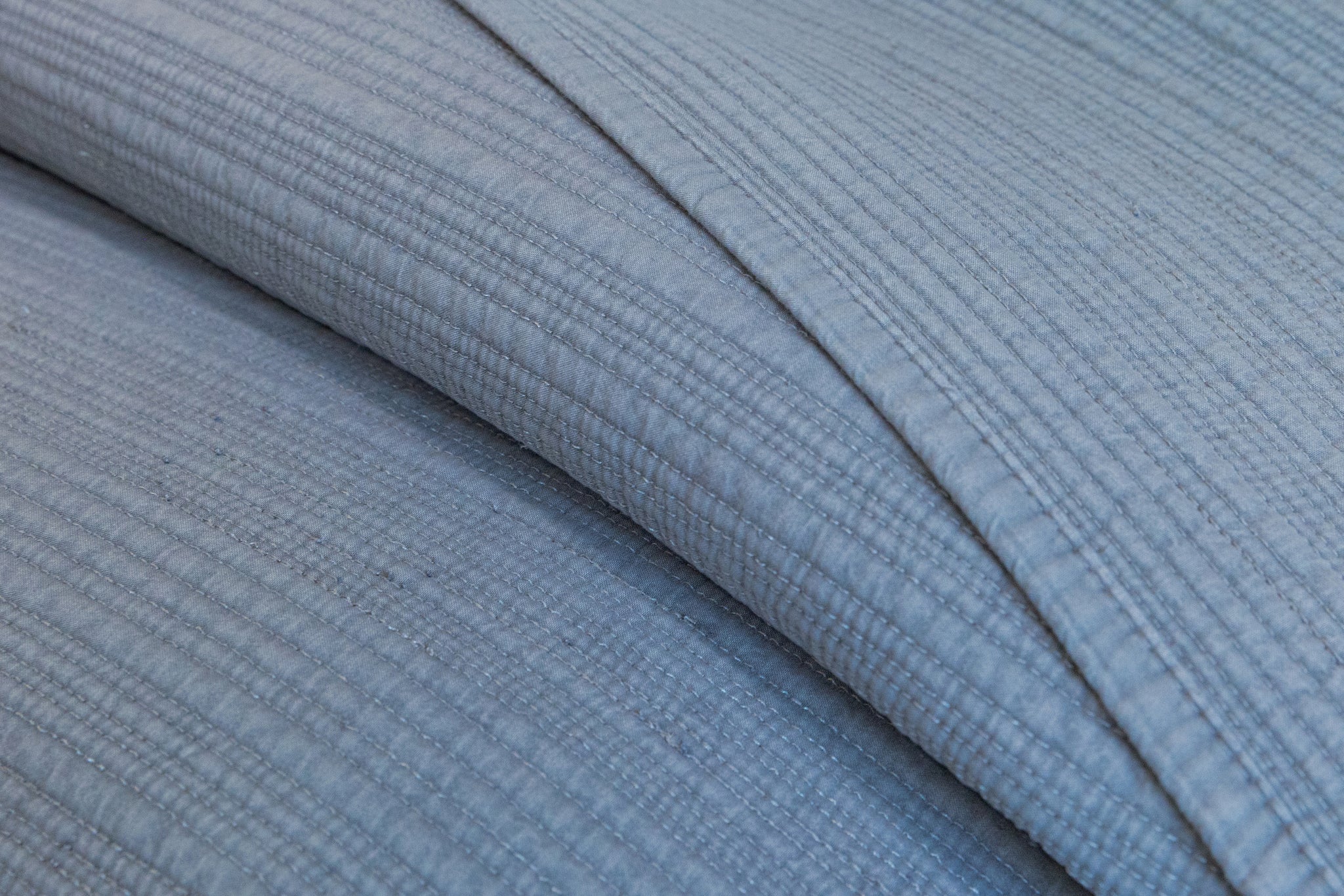 Close-up of the texture of the So Soft Stonewash Quilted Blanket Set, highlighting its softness