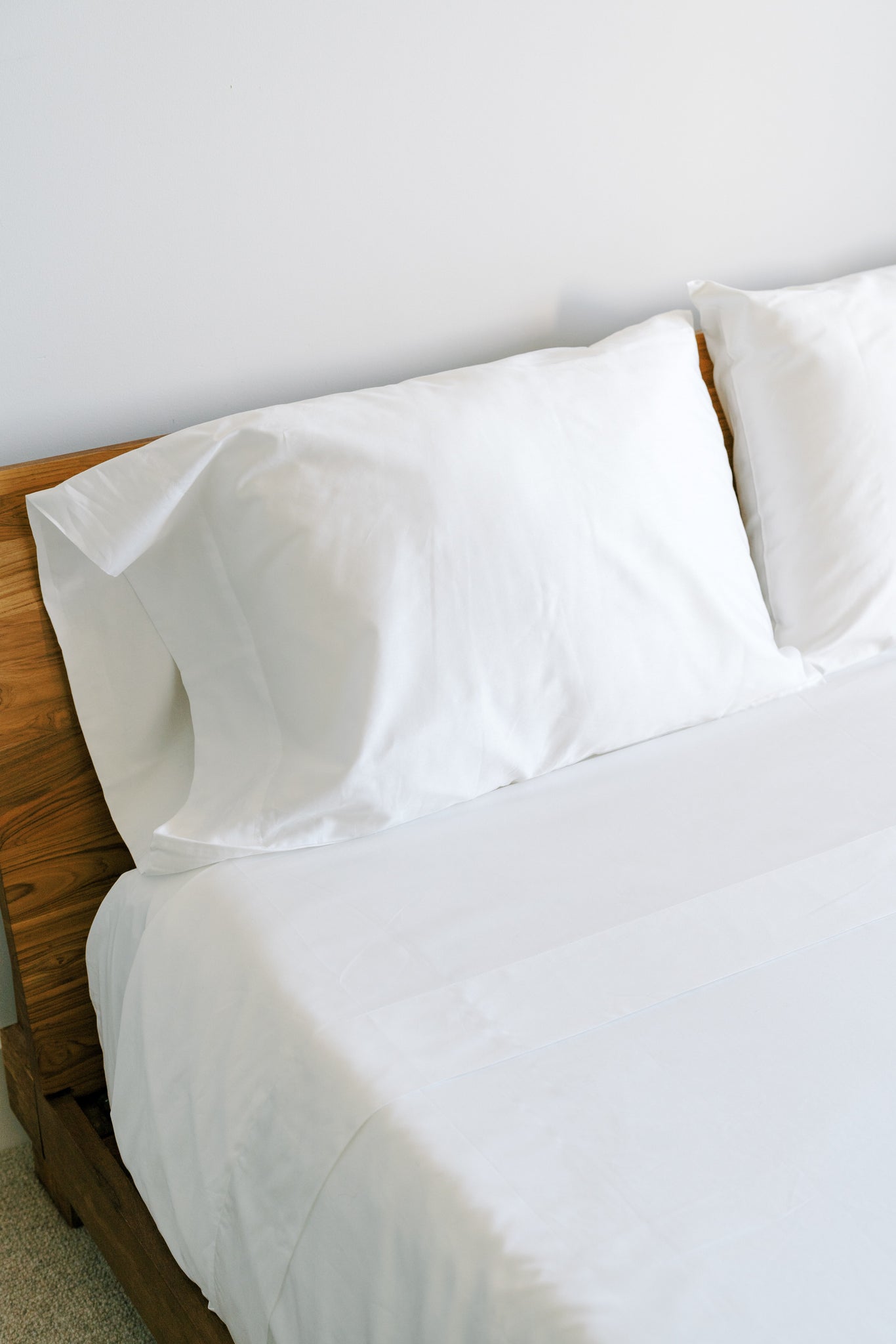 Minimalist bedroom decor featuring pristine white bedding