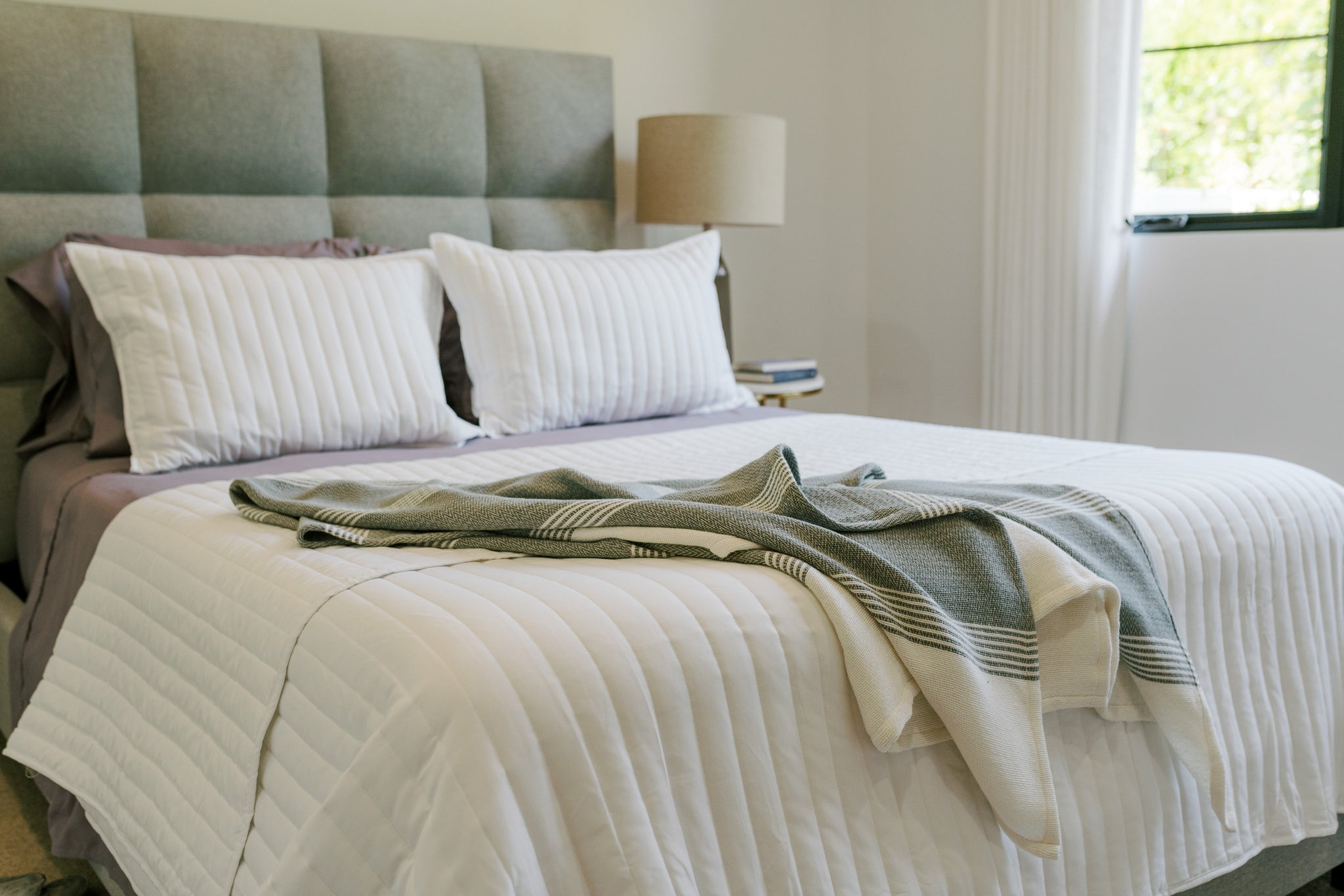 Look for bedding, blankets, and coverlets or duvets that complement your neutral color scheme