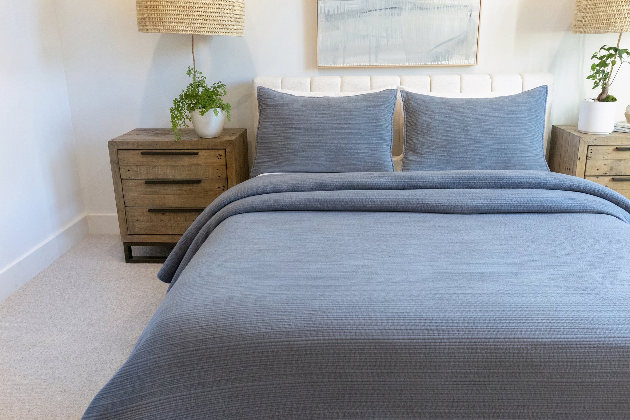 So Soft Stonewash Quilted Blanket Set being layered on a bed, demonstrating its layering versatility.