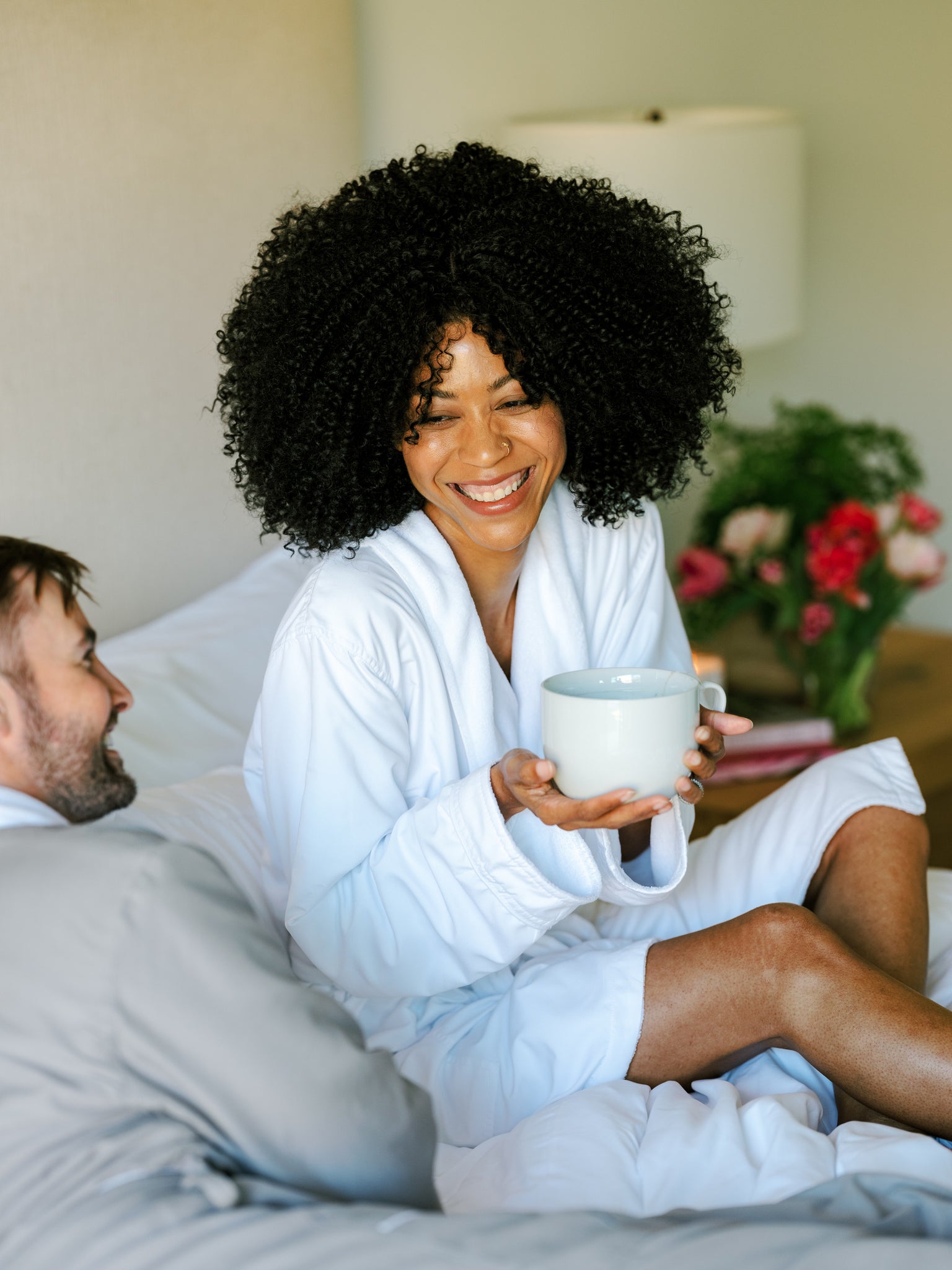 Woman laughing and drinking hydrating peppermint tea