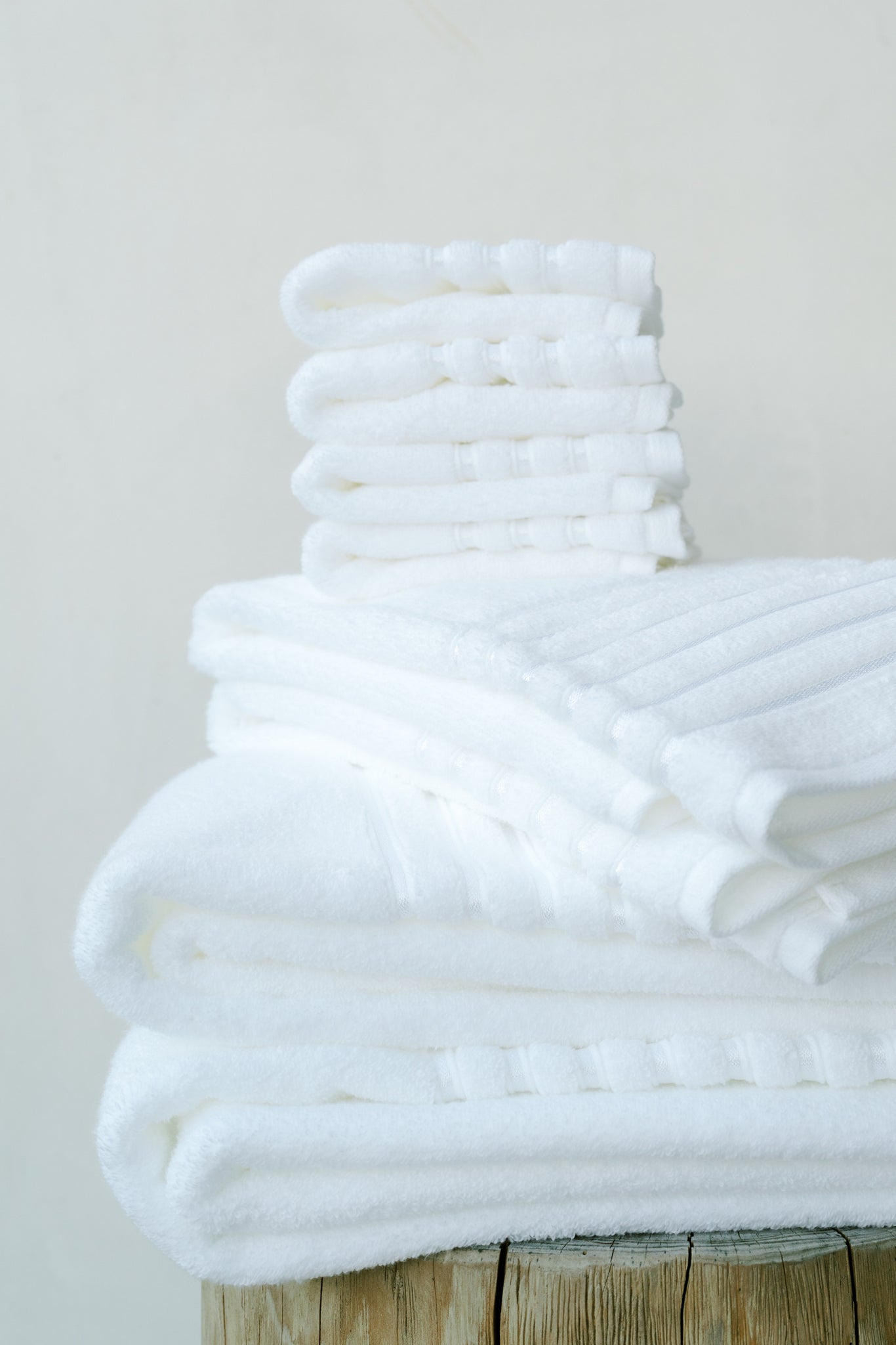 Towels neatly folded and stacked in a bathroom