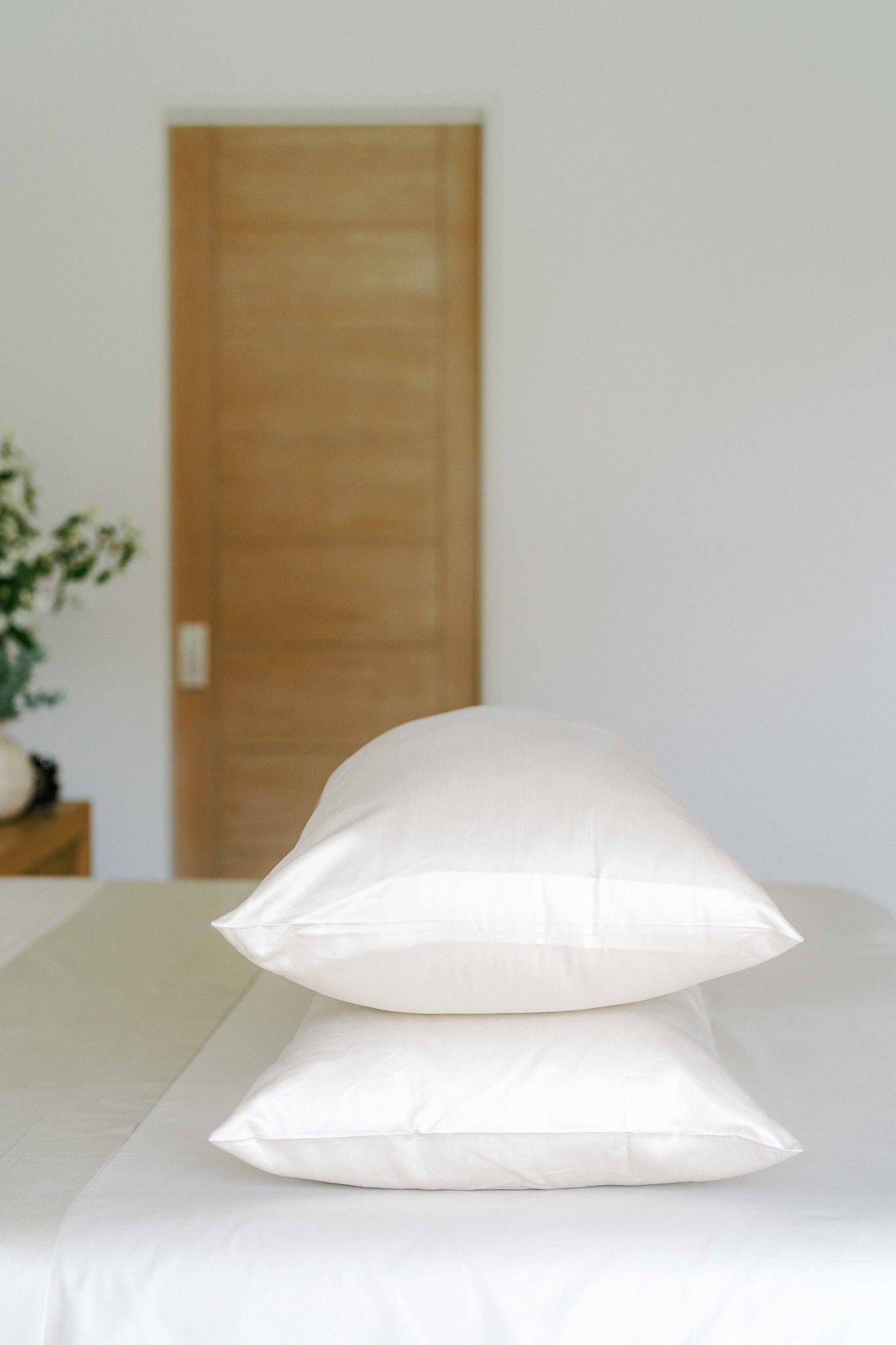 Minimalist bedroom decor featuring pristine white bedding