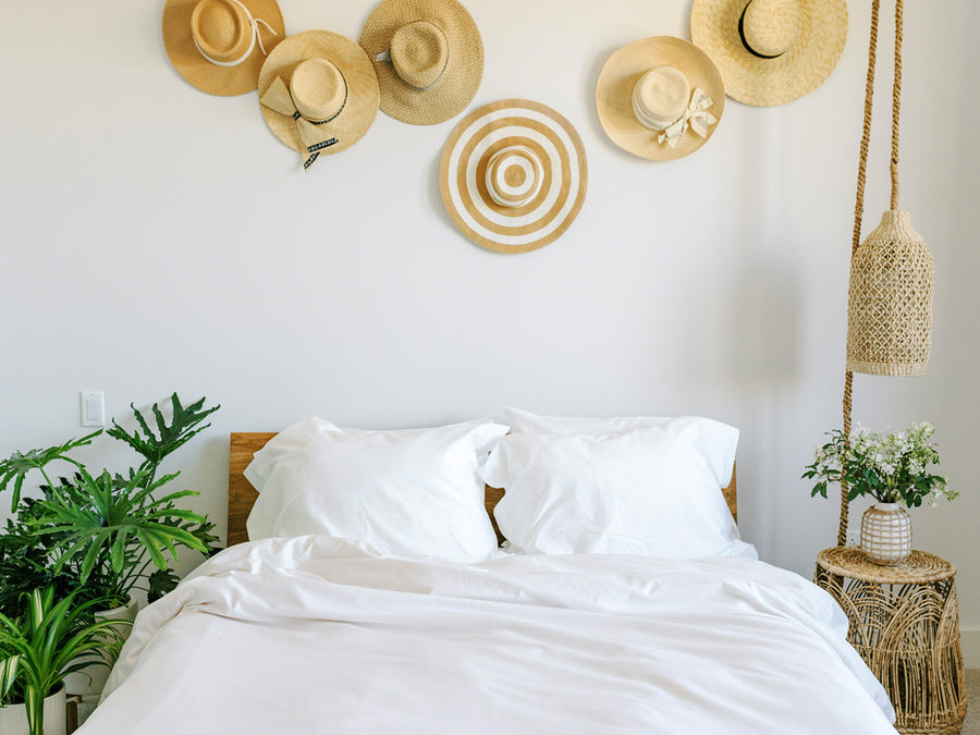 bed with hats on wall