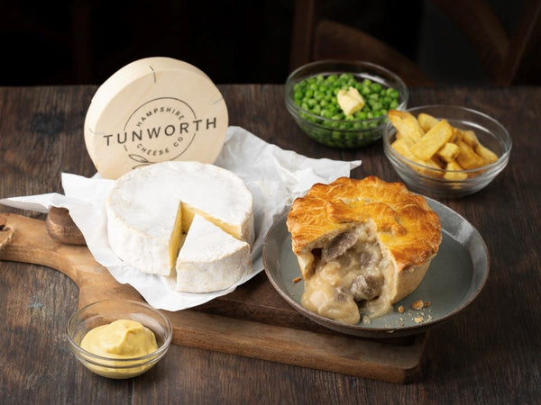 Tunworth cheese pie with a wheel of cheese and a selection of accompaniments