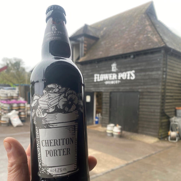 Bottle of ale with brewery in background