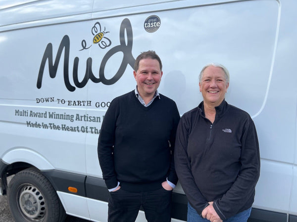 Christian and Stacey standing together in front of a Mud Foods van