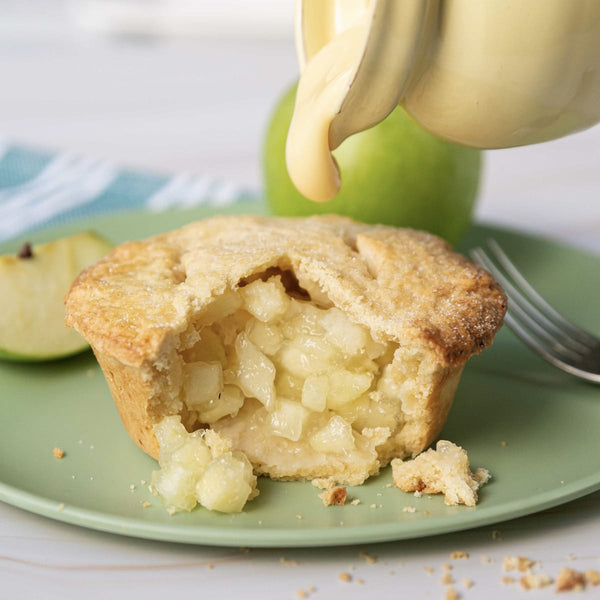 Apple pie with custard being pored on top