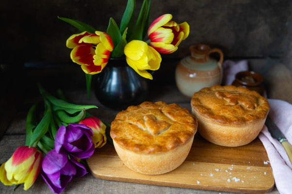 Two unopened pies with tulips