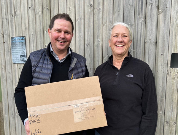 Christian and Stacey from Tunworth Cheese standing together with a box of Mud Foods pies