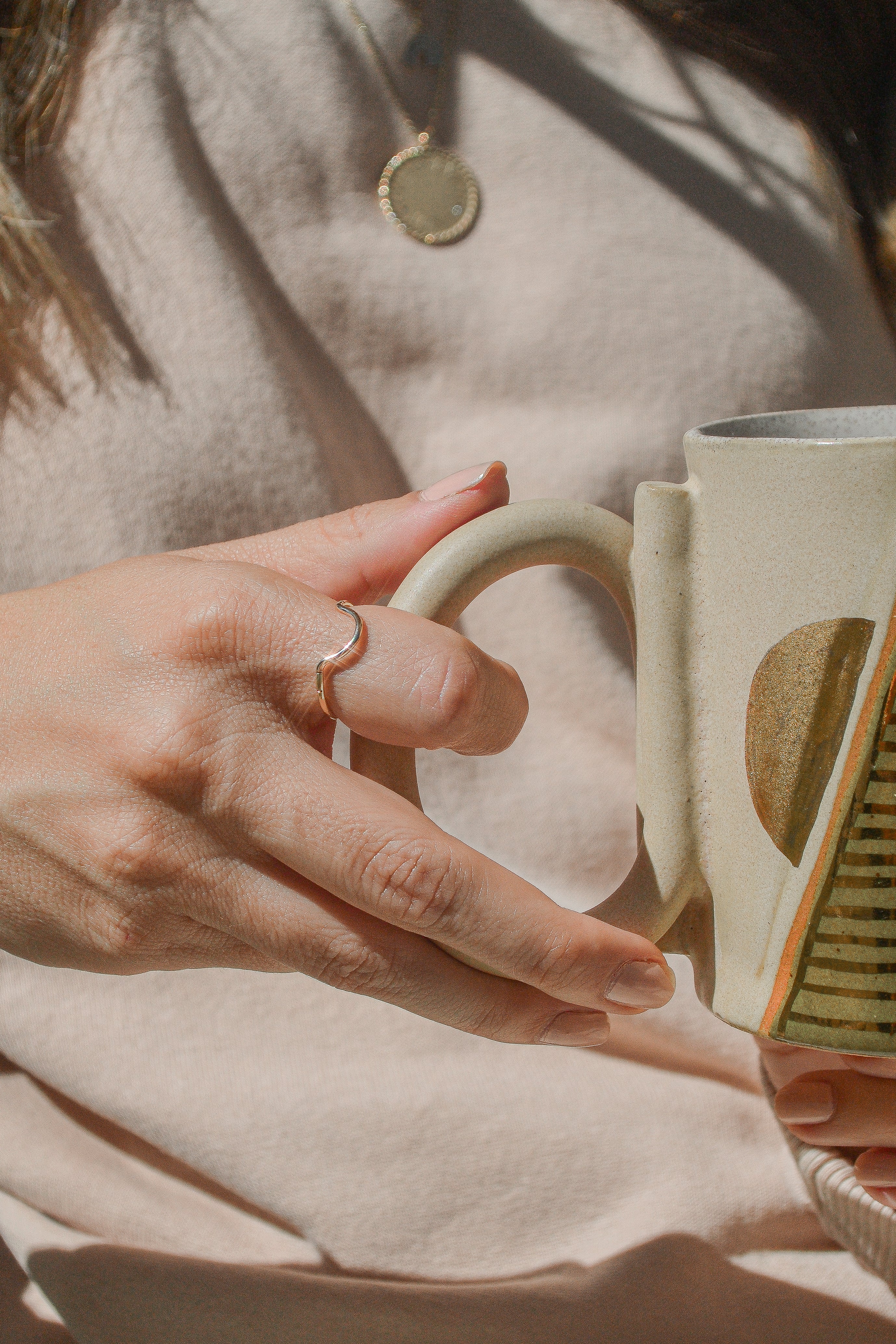 Gold varnished ceramics by Curious Clay & stackable rings, at Thread Spun. Photography by Ava Sophia of Dr. Cassidy Freitas LMFT