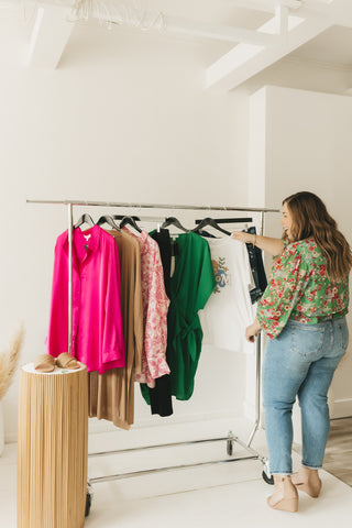 Plus size women in front of hot pink and green theme capsule wardrobe.