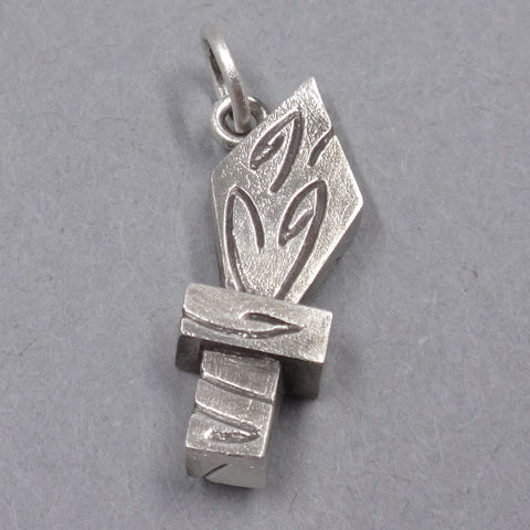 A tiny sterling silver charm in the shape of a wooden play sword.