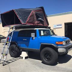 blue 2007 Toyota FJ cruiser with Rocky Black Line-X iKamper Skycamp installed on Rhino-Rack Backbone Pioneer Platform