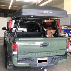 Green Toyota Tacoma with iKamper Skycamp Roof Top Tent on bed rack