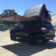 5th Gen Toyota 4Runner with Rocky Black LineX iKamper Skycamp 4x v2 on Prinsu rack with Rhino Rack Sunseeker Awning installed at Rhino Adventure Gear San Francisco