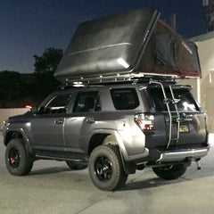Toyota 4Runner with black Line-X iKamper Skycamp Roof Top Tent installed on Gobi Rack with Ladder in California