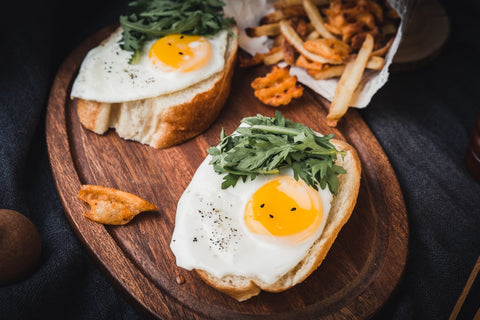 Sunny-side up eggs on toast with lettuce