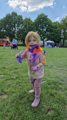 Young girl covered in colour powder