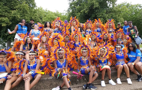 Group photo of Pure Elegance Carnival, the colour scheme is orange and blue