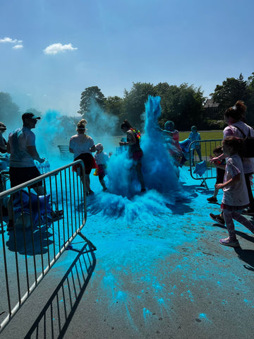 people throwing blue colour powder