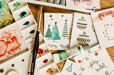 A range of hand painted Christmas cards on a table