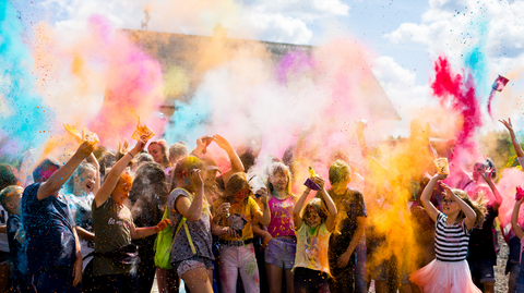 Children throwing colour powder outside