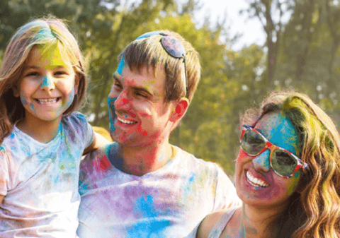 Family covered in colour powder