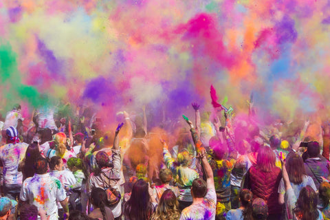Group of people celebrating Holi by throwing colour powder