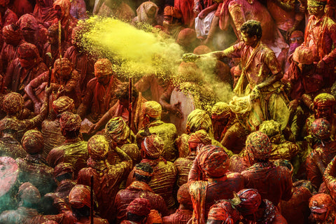 Group of people celebrating Holi covered in colour powder