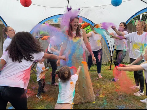 Megan's friends throwing colour powder at her