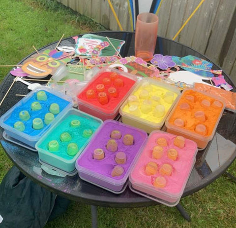 Colour powder all ready to be thrown in tubs on a table