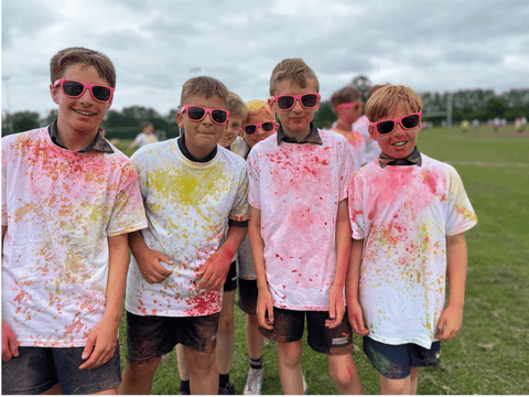 Kids covered in colour powder