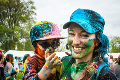 Mother and child covered in colour powder