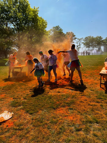 vibrant orange colour powder being thrown