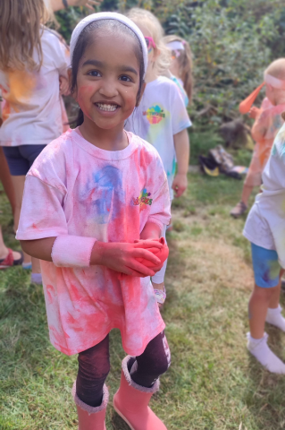 Girl holding colour powder hacky sack