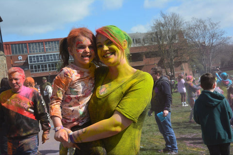 Mother and child covered in colour powder at a colour event