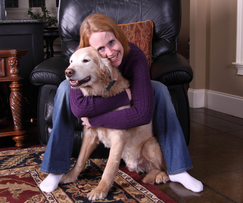 A woman bonding with her adopted dog with a hug