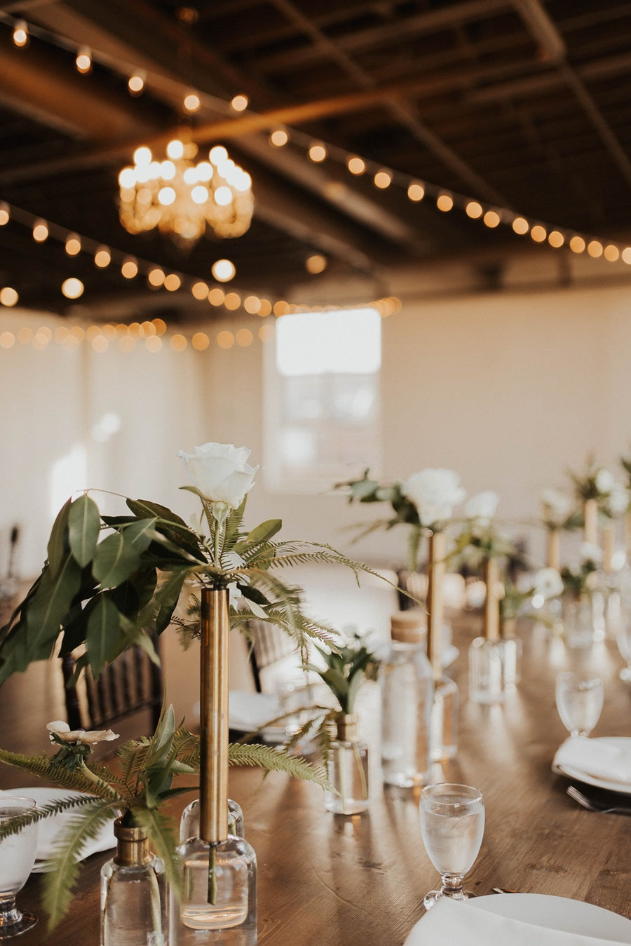 Arbor Loft reception photos, focusing on the greenery and roses in budvases.