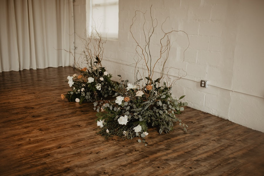 Closer shot of the arbor pieces. They have lots of texture and greenery with pops of white and toffee roses. Branching adds to the dimension creating additional height.