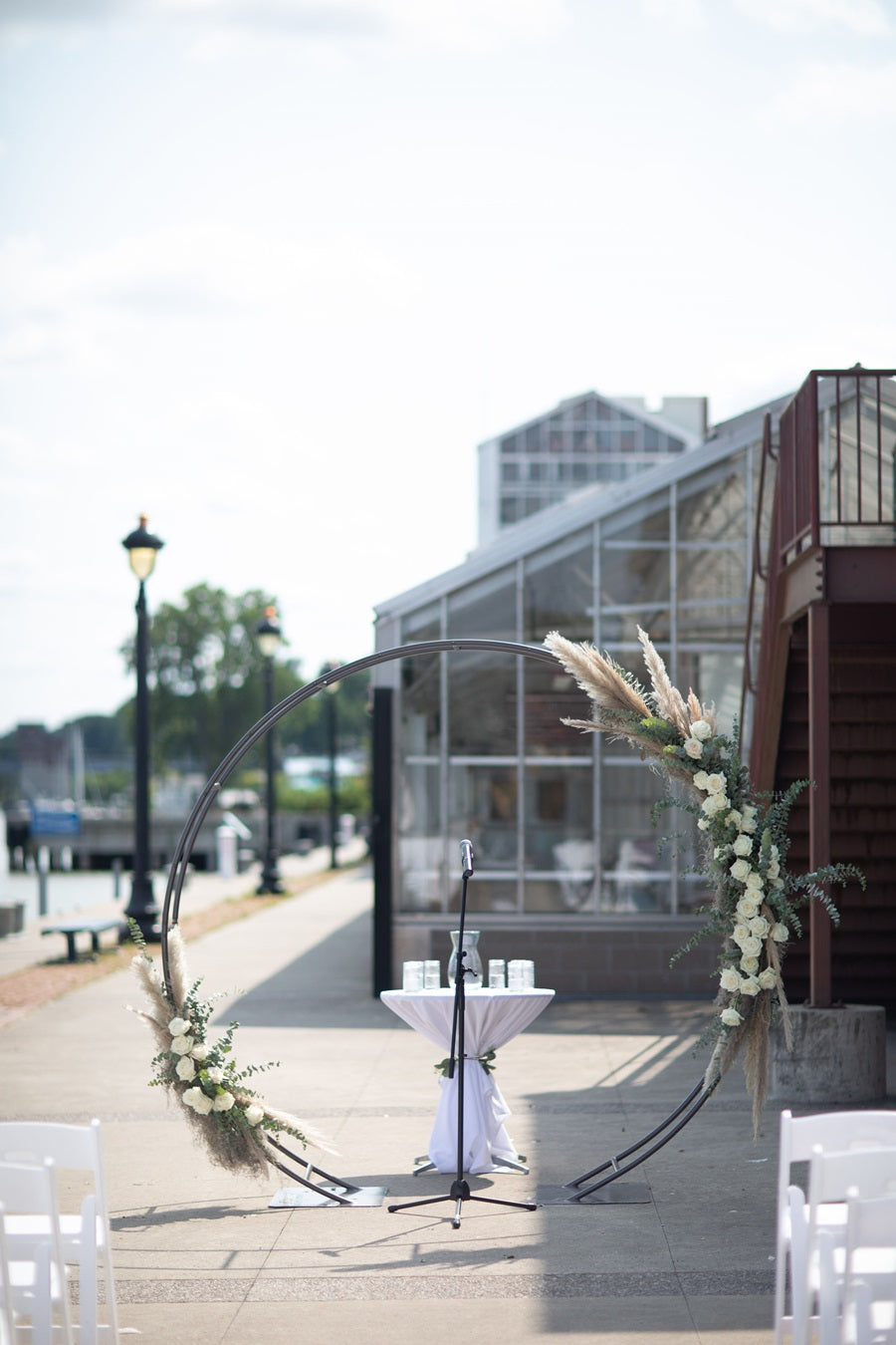 Circle arch on the walk outside Arbor at the Port wedding venue. Decorated with florals.