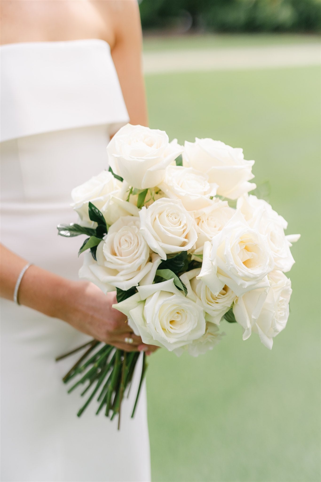 closeup up bride's white rose bouquet