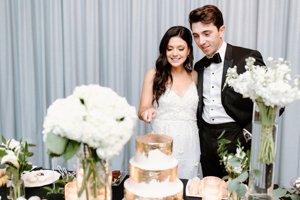 bride and groom cutting cake