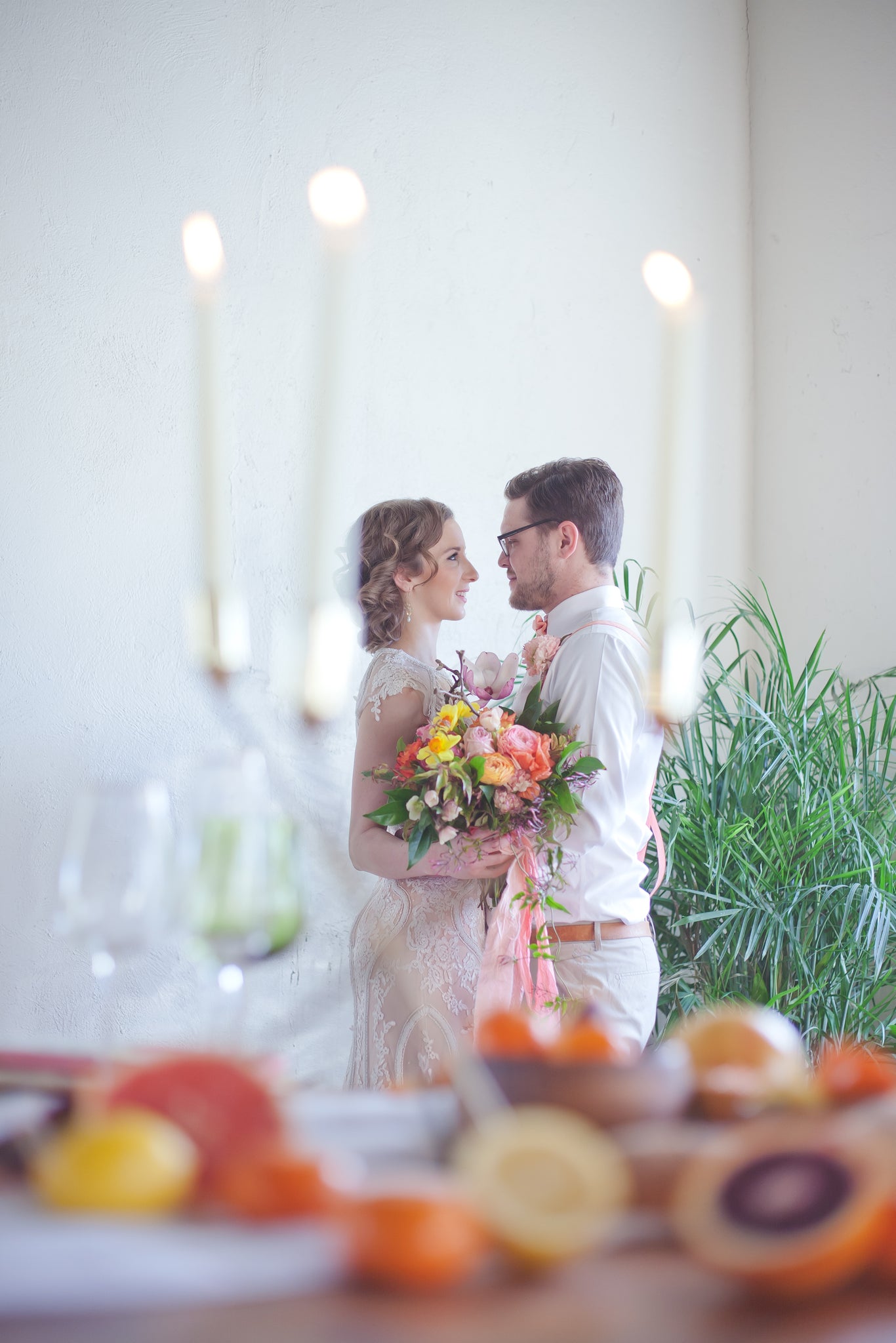 bride and groom embracing, bride holding bouquet 