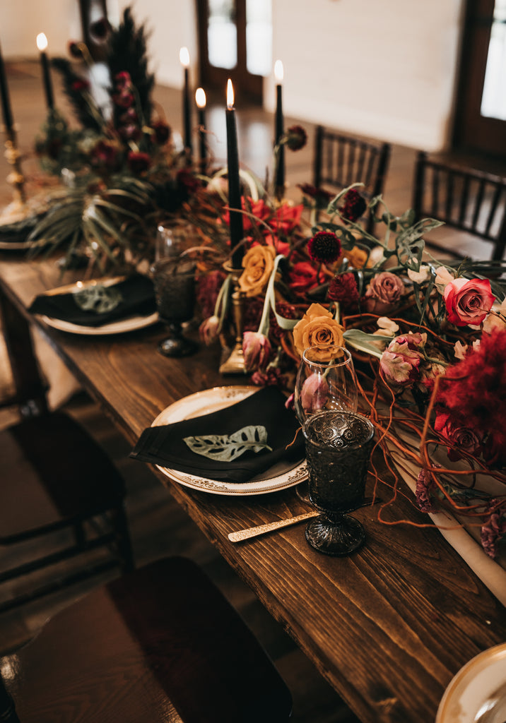 farm table with table settings and floral centerpieces 