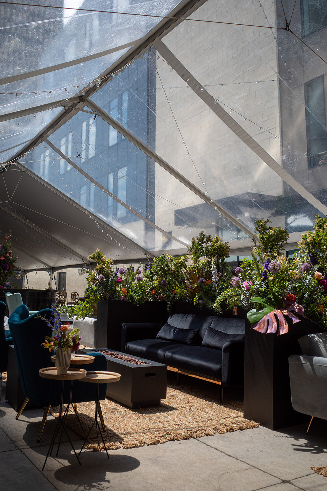 lounge seating with floral planters in background 