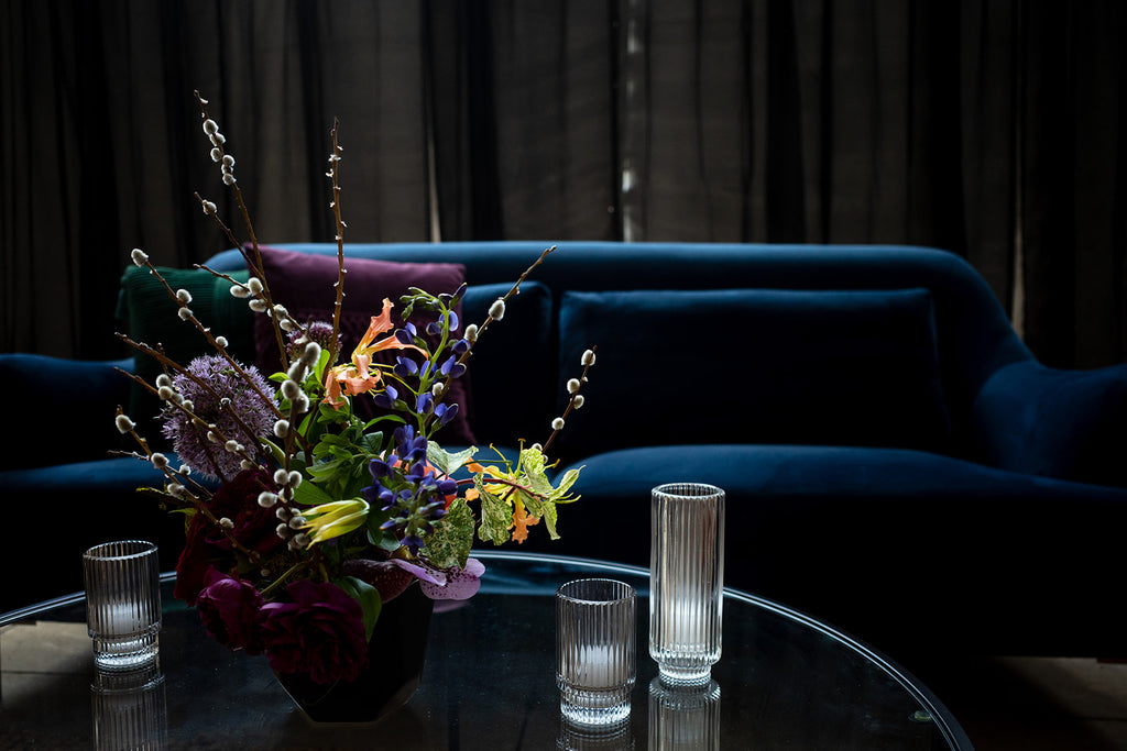 floral arrangement on coffee table with sofa in background