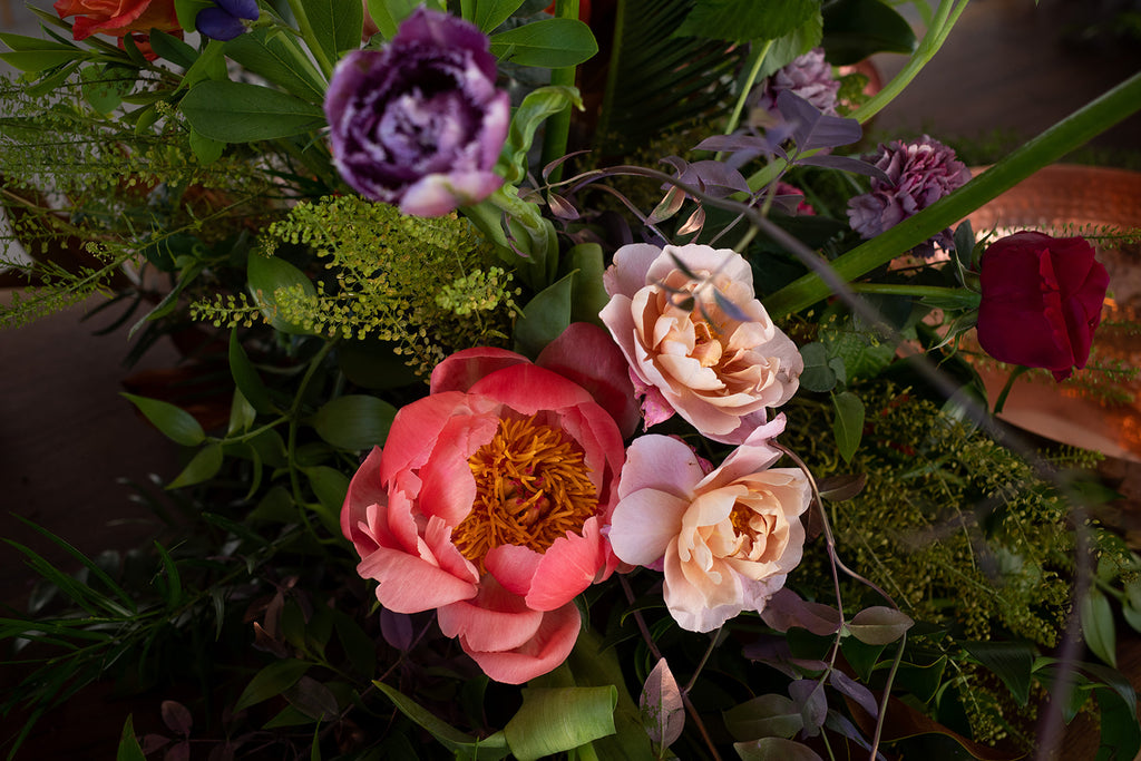 closeup of coral peony and other blooms