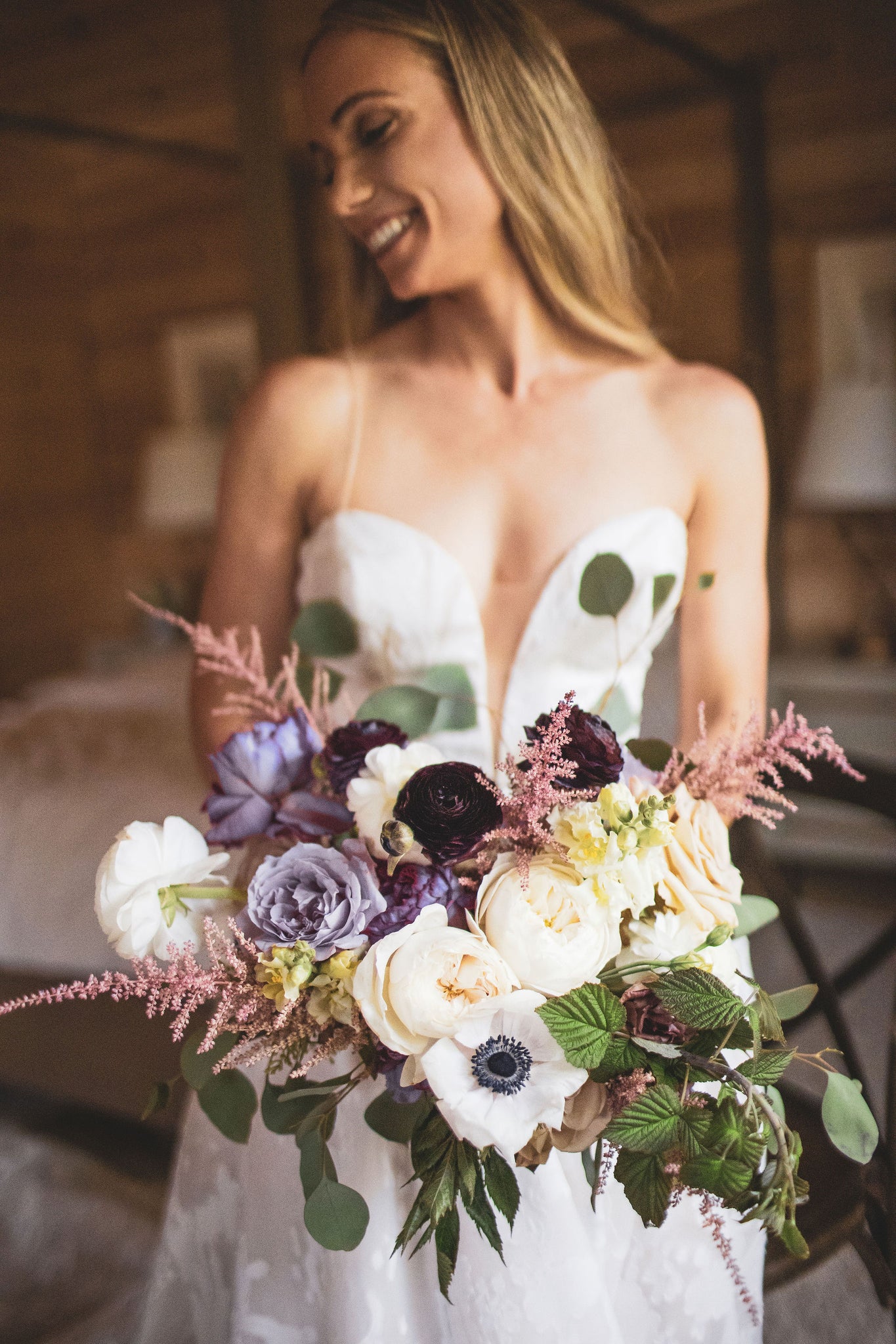 Bride holding bouquet of white and lavender blooms